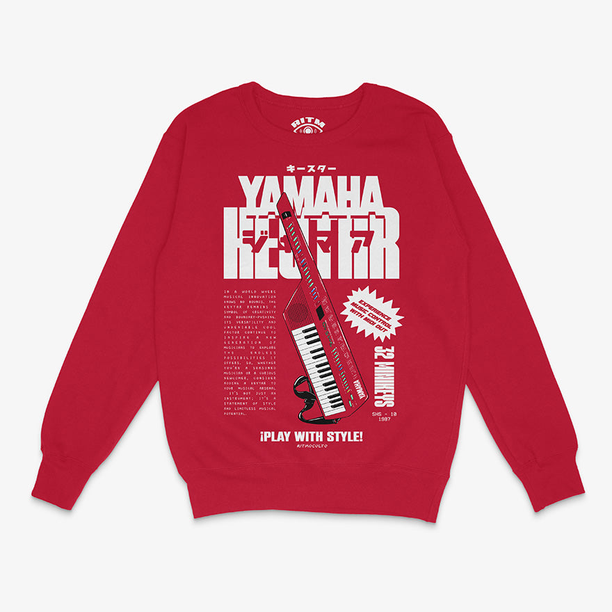 Polerón de cuello redondo de color rojo. Diseño frontal del Yamaha Keytar SHS-10. Texto que dice "Yamaha Keytar" y "¡Play With Style!"